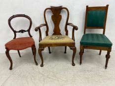 An early Georgian style walnut armchair with scrolled back and shaped splat and arms over a