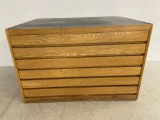 A mid-century ash plan or architects chest with rectangular black laminated top over six long