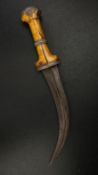 A 19th century Indian Jambiya dagger having a curved steel blade with a shaped white metal mounted