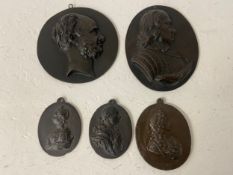 A pair of bronze raised relief plaques, George III and Queen Charlotte along with others to