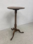 A 19th century mahogany occasional table with circular top over a turned stem raised on shaped and