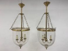 A pair of large 20th century Italian style brass mounted glass pendent lights each with central stem