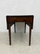 A 19th century mahogany drop flap Pembroke table fitted with frieze drawer on turned tapering