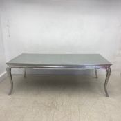A contemporary dining table with plate glass top and shaped frieze raised on cabriole supports. H.80