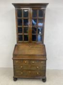 A William and Mary oak three section bureau bookcase having a moulded cornice over two glazed