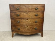 A Georgian mahogany bowfronted chest of two short over three long graduating drawers on swept