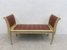 A Louis XVI style window seat having two scrolled, painted and carved framed side rests and seat