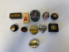 A Russian silver pill box with hand painted decoration to the lid along with ten similar papier