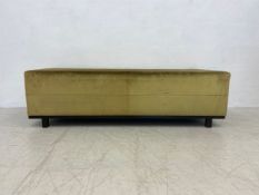 A contemporary ottoman footstool in velour upholstery on square tapering supports. H.46 W.146 D.