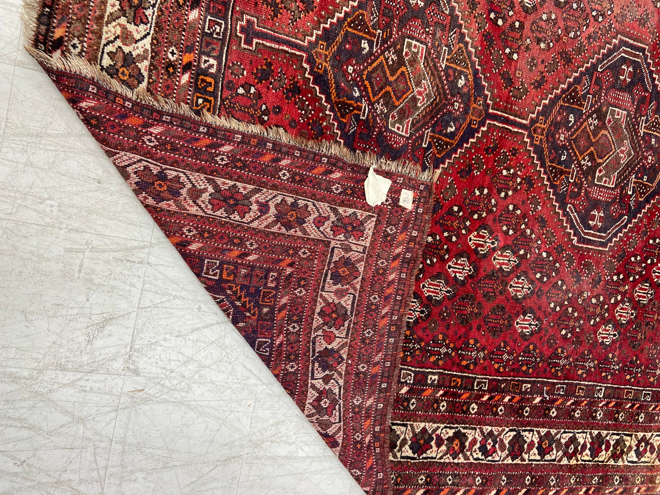 A Shiraz carpet with triple central pole medallions with stylised flowerhead motifs across the - Image 4 of 4
