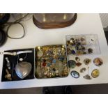 A mixed collection of costume jewellery to include hand painted brooches etc.
