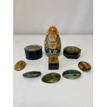 A collection of five signed and hand painted Russian papier mache oval pin badges along with three