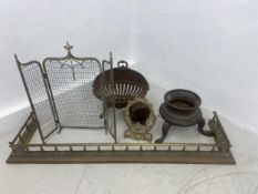 A mixed lot to include a brass fire kerb, cast iron footed urn, a cast iron clam-shell fire