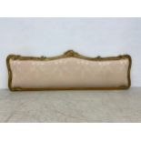 An early 20th century Rococo carved giltwood headboard in damask upholstery. 202x69cm. (mattress