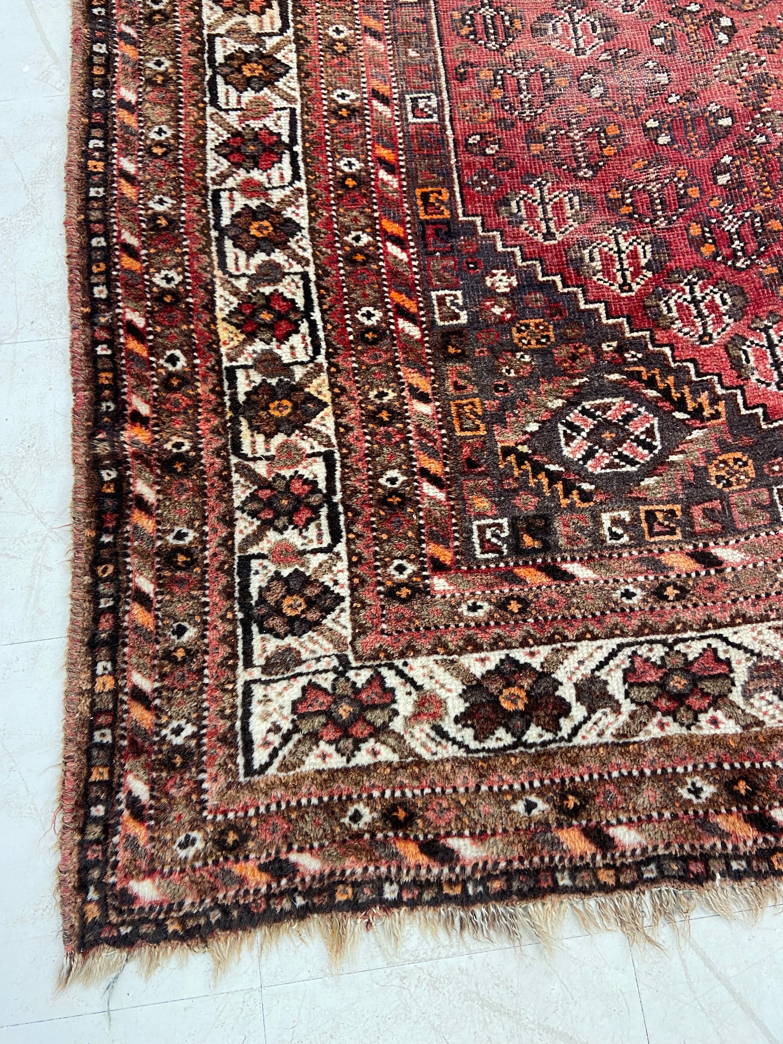 A Shiraz carpet with triple central pole medallions with stylised flowerhead motifs across the - Image 3 of 4