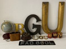 A miscellaneous collection of items to include painted lettering, a vintage globe and binoculars,