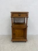 A C.1900 bedside cabinet having a square top with single frieze drawer raised on turned supports