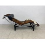 A Le Corbusier style LC4 chaise in leather and cowhide upholstery on a blackened aluminium and