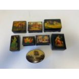 A collection of eight lacquered Russian papier mache dressing table boxes with hand painted