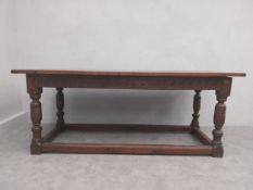 A 17th century and later oak refectory table with planked top on baluster stretchered base. L.185