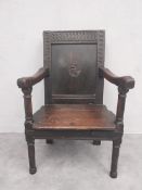 A 17th century oak wainscott armchair with carved panelled back on stretchered supports. H.95.5cm