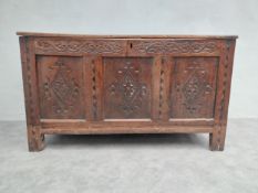 An early 18th century oak coffer with carved lozenge panels on stile supports. H.72 W.123 D.55cm