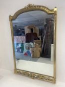A vintage Italian wall mirror in heavy brass arched scrolling foliate frame. H.98 W.62cm.
