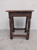 An 18th century oak joint stool the moulded plank top on turned stretchered supports. H.54.5 W.44.