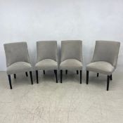 A set of four contemporary upholstered dining chairs with deep buttoned backs on square tapering