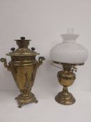 A 19th century brass tea urn with cyrillic inscription and a 19th century brass and milk glass oil