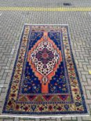 An Anatolian Taspinar carpet, the stepped diamond lozenge medallion on a sapphire ground with