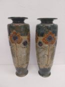 A pair of early 20th century Royal Doulton stoneware vases with stylised sunflower decoration,