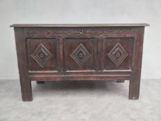 A C.1800 carved oak coffer of panelled construction on stile supports. H.78 W.130 D.49cm