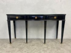 A lacquered console table fitted with three frieze drawers on square tapering legs terminating in