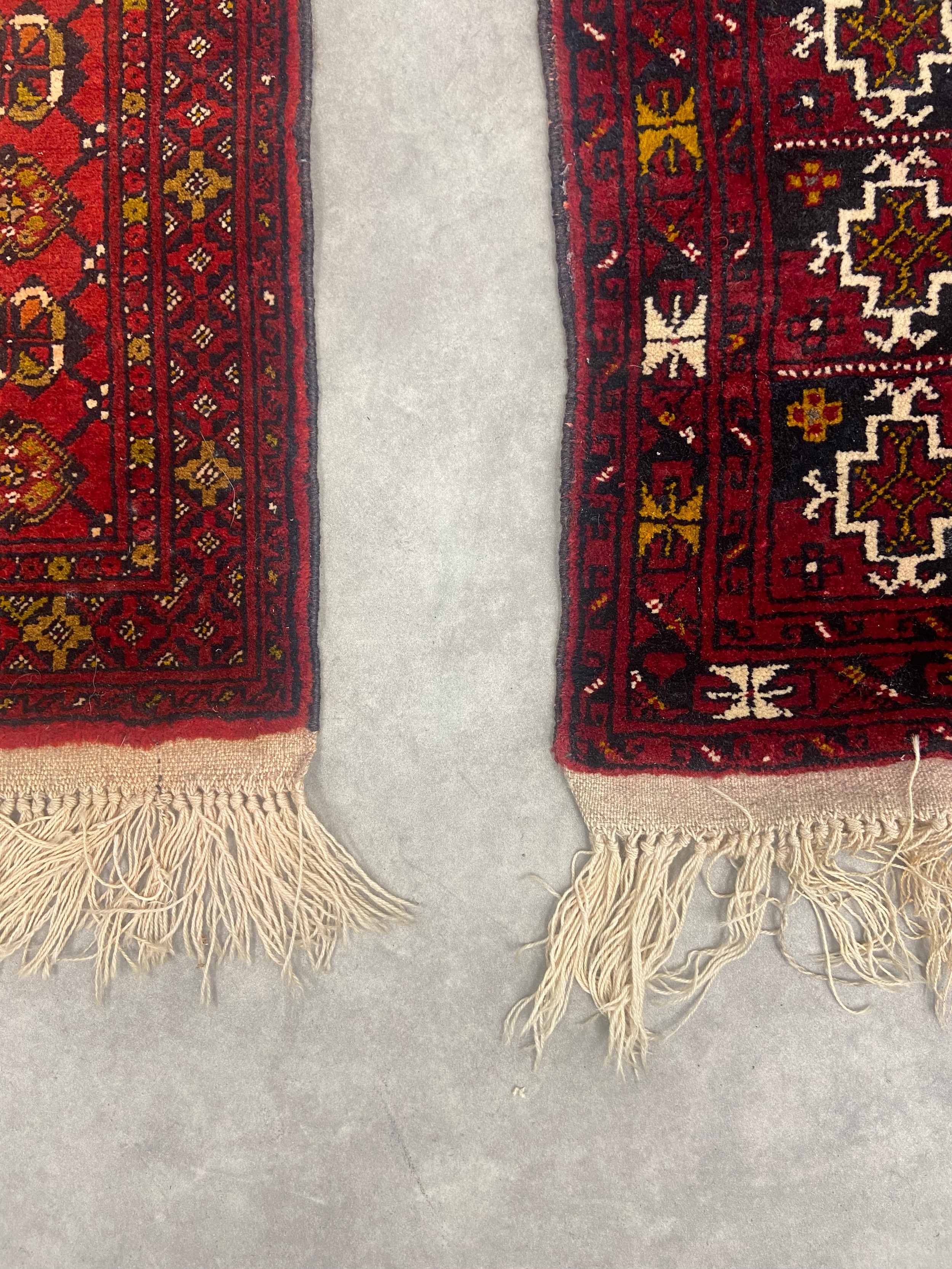 Two small Bokhara mats with repeating medallions on burgundy grounds. 120x56cm. - Image 2 of 3