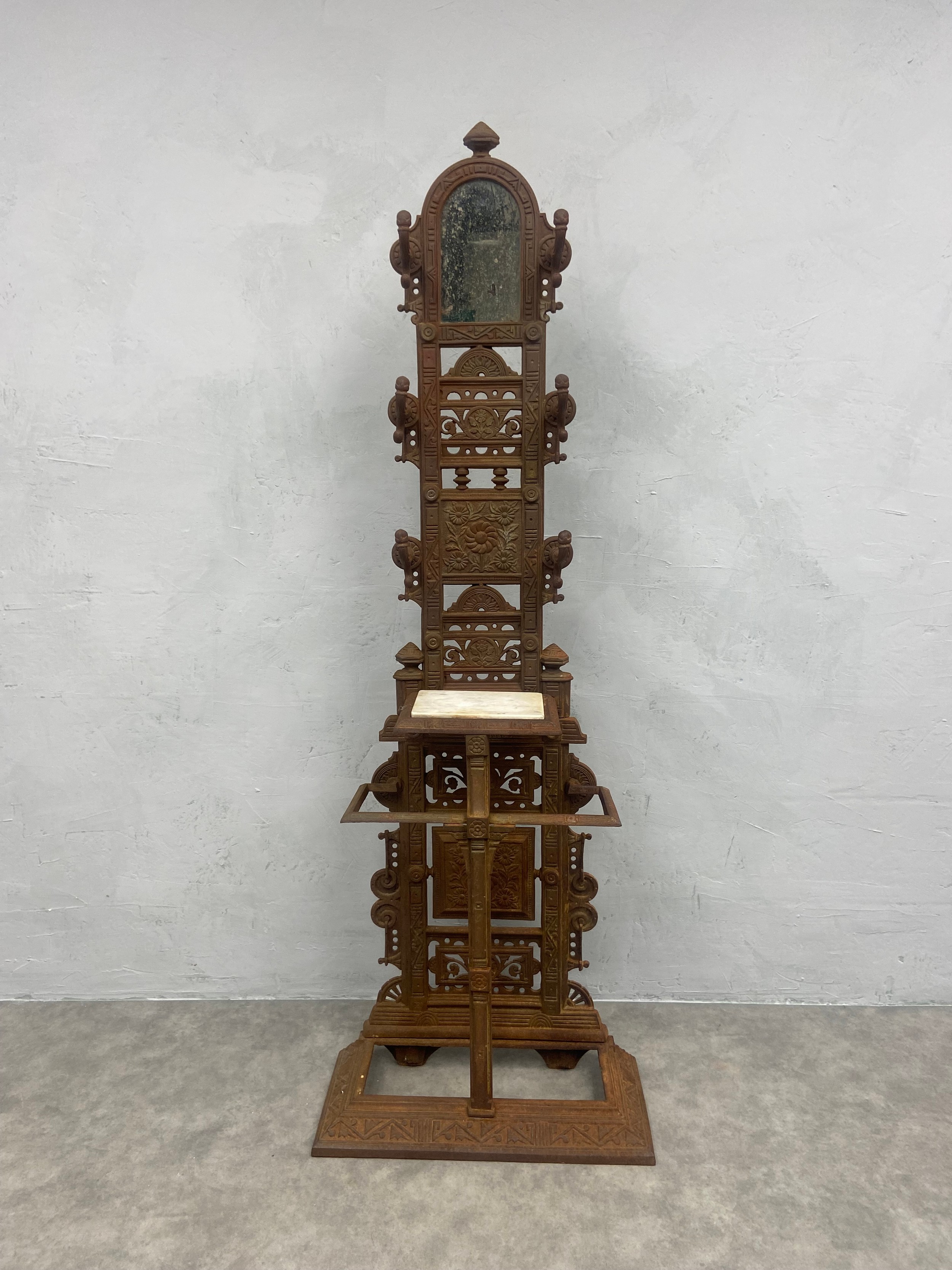 A Victorian cast iron hallstand fitted with mirror and marble shelf with foundry mark to the back.