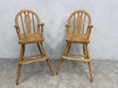 A pair of Windsor wheelback style beech children's high chairs. H.82cm