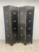 A painted and lacquered four panel screen or room divider each panel inlaid with Chinese writing on
