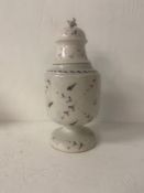 A 19th century lidded porcelain urn having a cup and cover finial over a hand painted foliate body