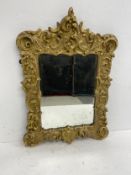 An early 20th century carved giltwood Rococo style wall mirror with original plate. 68x48cm.