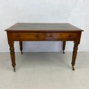 A 19th century mahogany and pine writing table with inset tooled leather top above two frieze