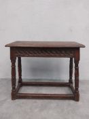 A 17th century oak joint stool with planked top above carved frieze on turned stretchered