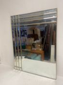 A vintage brass framed wall mirror with bevelled glass panels. H.100 W.79cm.