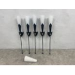 A set of five metal wall lights in the form of heraldic torches with 6 white glass Christopher Wray