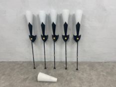 A set of five metal wall lights in the form of heraldic torches with 6 white glass Christopher Wray
