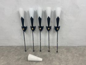 A set of five metal wall lights in the form of heraldic torches with 6 white glass Christopher Wray