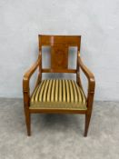 A contemporary Empire style armchair with hand decorated splat and stuffover striped upholstery on