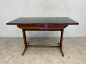 A mid century Cassina writing table with black plate glass top above frieze drawers on metal clad