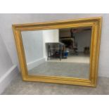 A large contemporary giltwood and gesso wall mirror with bevelled plate. 95x120cm.
