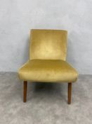 A mid century salon chair on circular section tapering teak legs. H.73 W.52cm